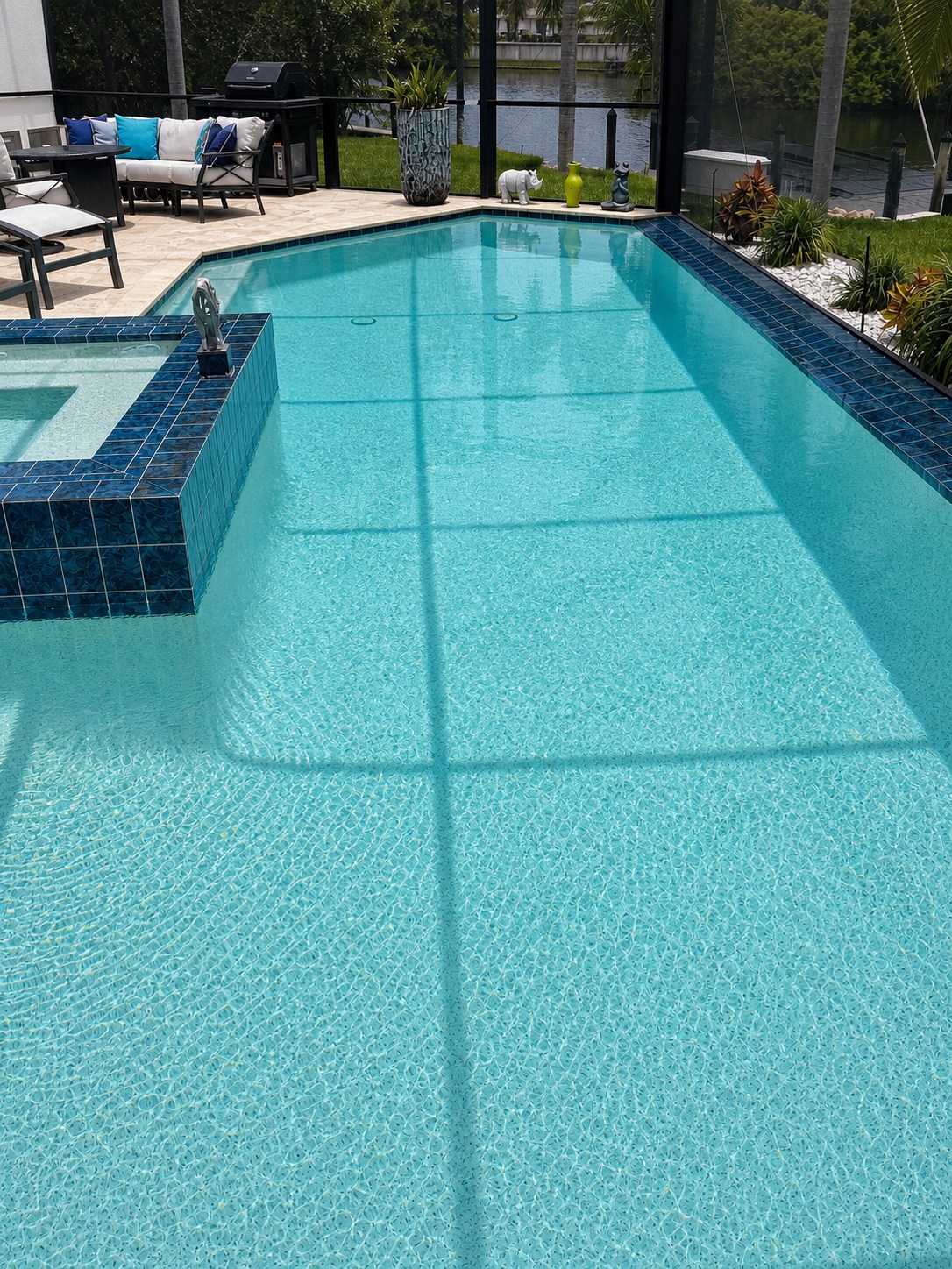 Clear residential pool with a tiled spa in Southwest Florida