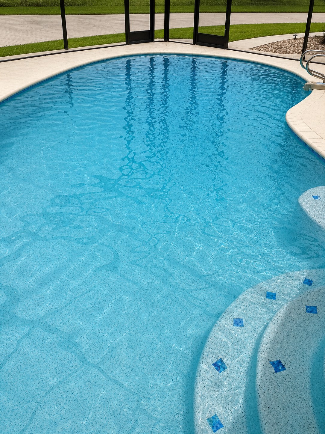 Blue residential swimming pool with curved entry steps